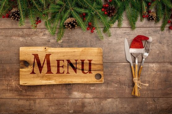 festive-new-year-christmas-menu-concept-board-with-menu-text-christmas-decorations-cutlery_256259-1846